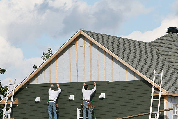 Professional Siding technician working in Dover, MA
